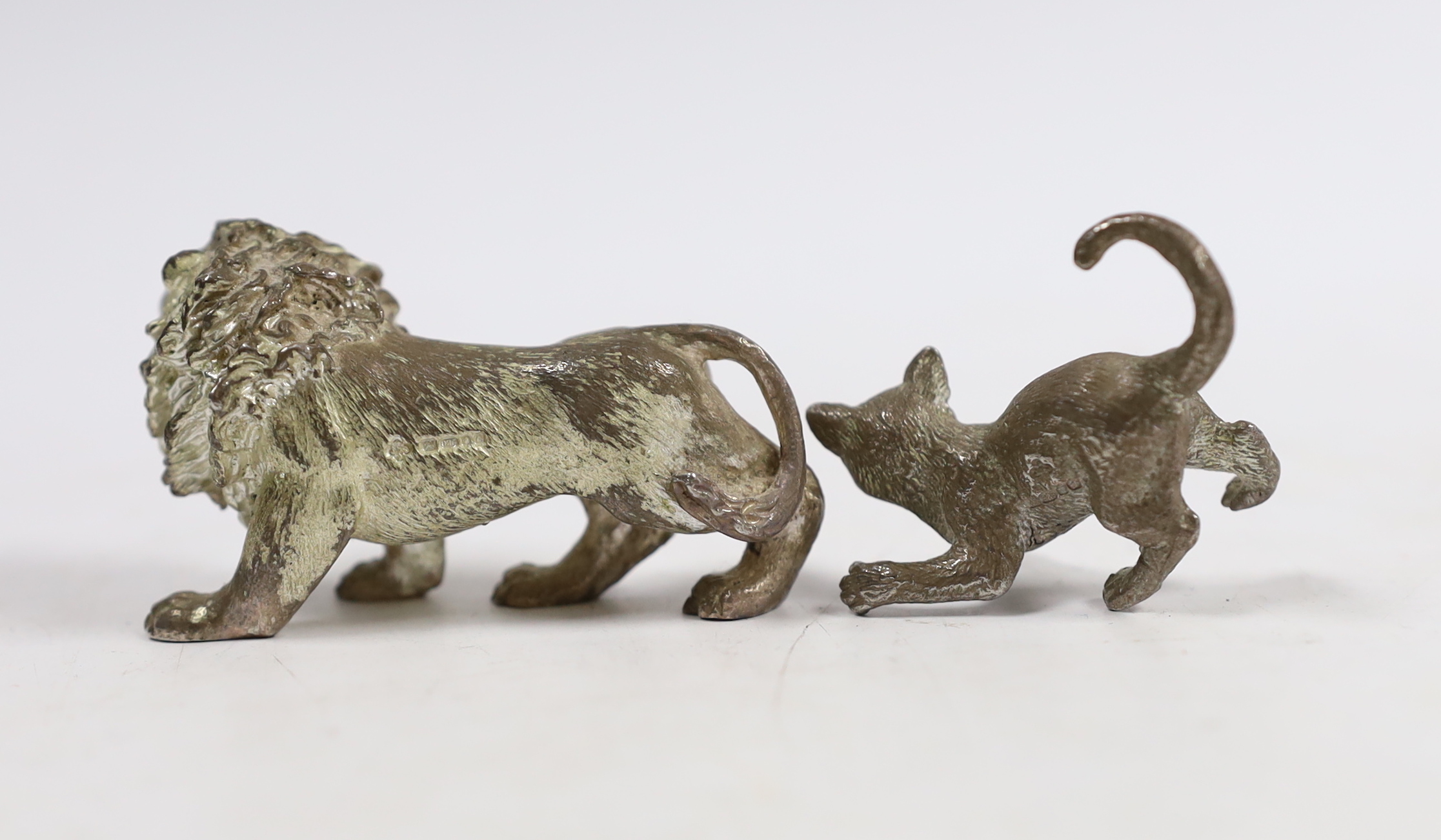 Two early 21st century silver miniature model animals, lion and playful kitten, London, 2003, lion length 55mm.